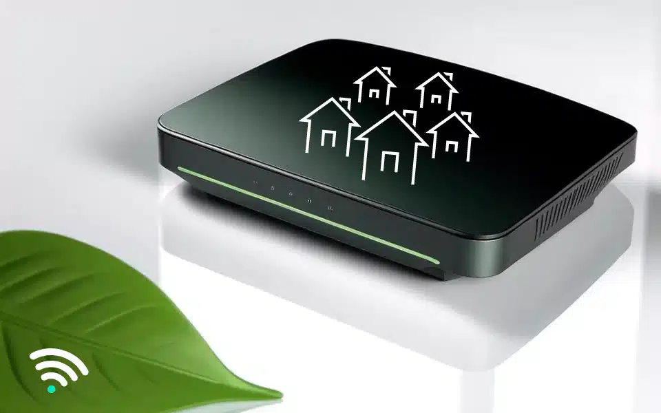 a modern Wi-Fi router with a sleek, black design. The router has a series of LED indicators on the front panel, with the numbers 1 to 4 visible, which typically represent Ethernet port connectivity. A bright green LED strip runs horizontally along the lower front edge, suggesting active network status. The router's surface displays a white iconography of five houses arranged in a network pattern, symbolizing residential ips.