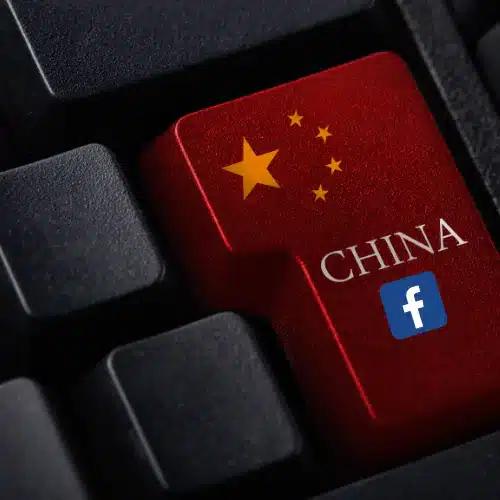 Person at computer accessing Facebook through VPN, with Great Wall of China imagery in the background